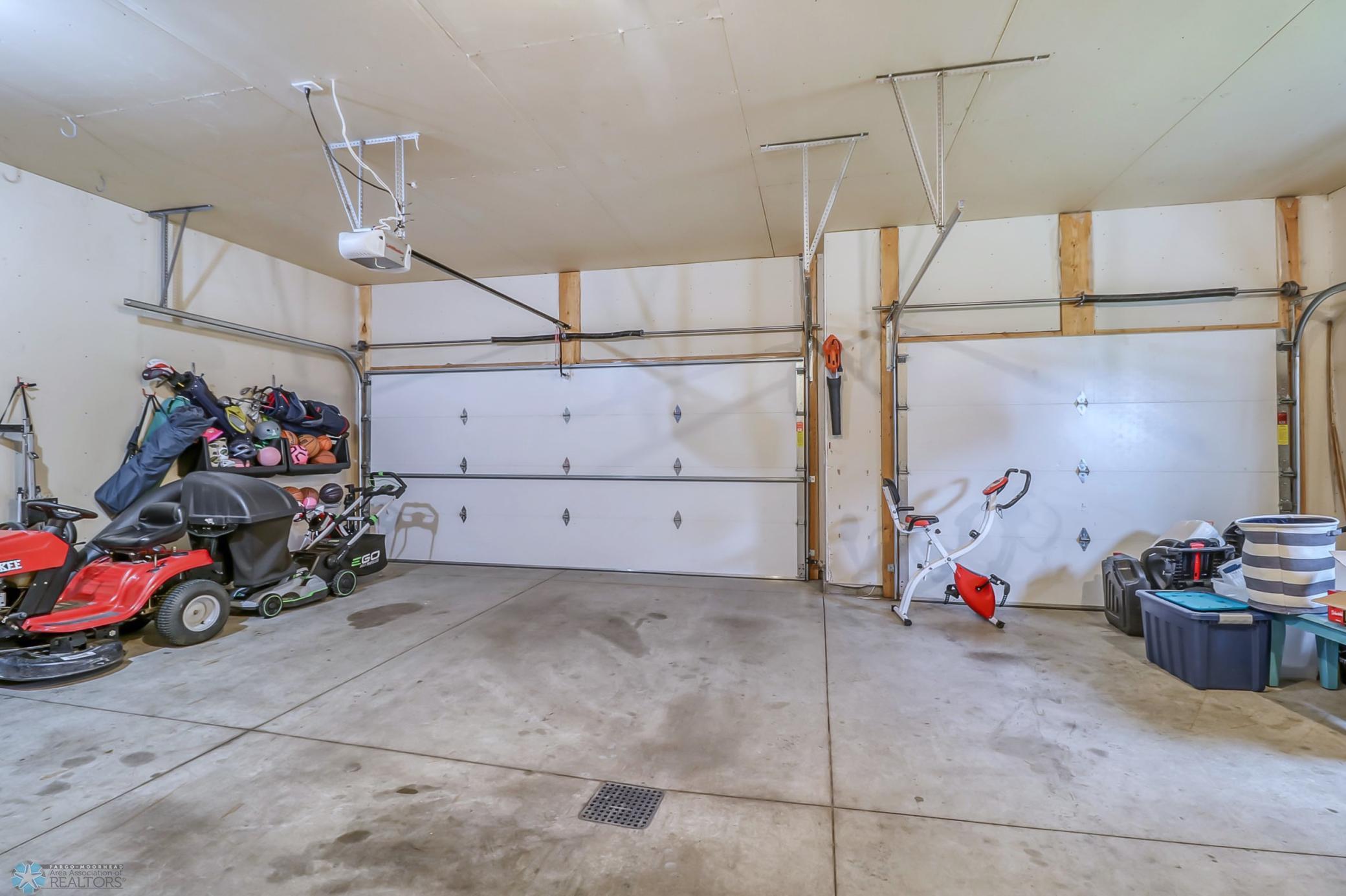 Three stall garage with heat, insulation and a floor drain. Access to back yard via service door too.