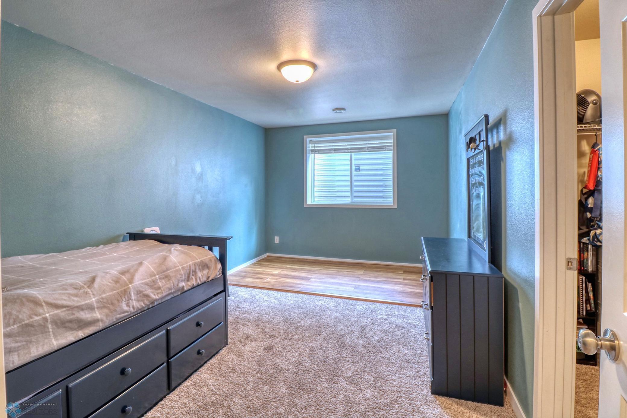 Basement Bedroom (4) - laminate "sport court" floor shown can/will be removed & is on top of existing carpet.