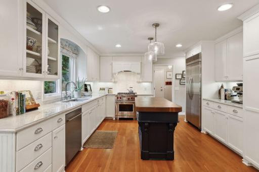 A chef's delight with timeless appeal. Center island with butcher block top.