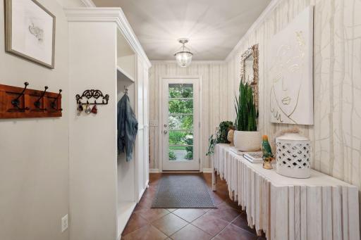 You may not know it now, but an exterior mudroom door is life-changing! Don't miss the built-in lockers and indestructible tile flooring.