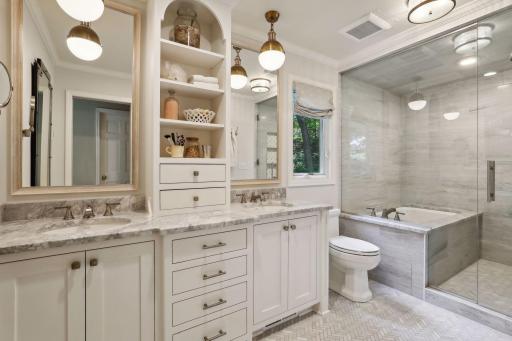 Stunning primary bath offering ample storage and spa-like finishes. Heated floors!