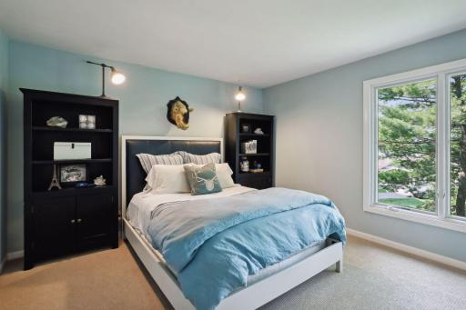 Upper-level bedroom with seasonal lake views.