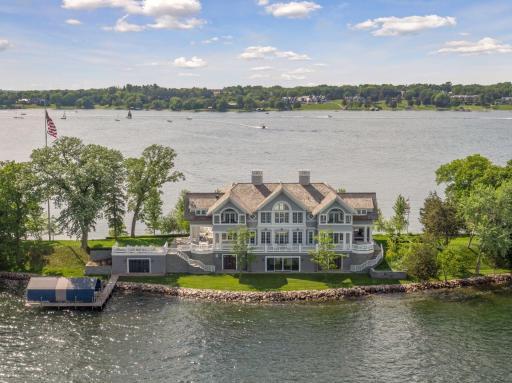 A landmark luxury estate on a spectacular private peninsula in Woodland. Almost 1,700 feet of frontage on stunning Wayzata Bay.