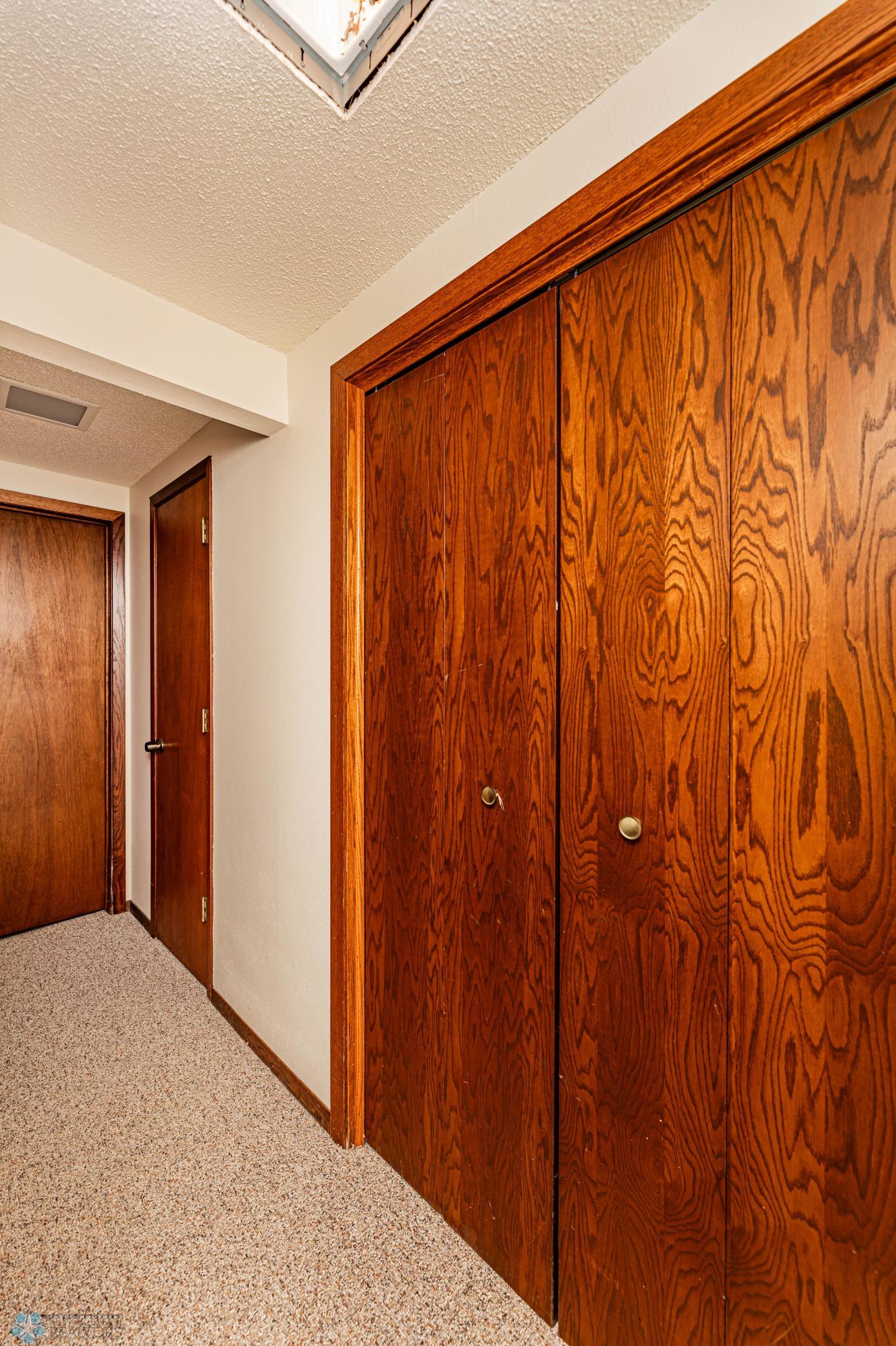 Downstairs hallway with extra storage closets