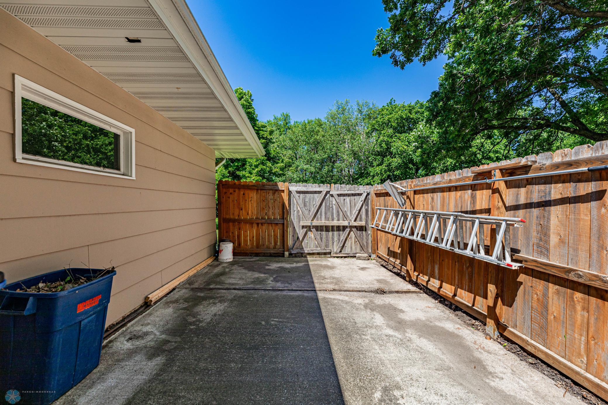 Enclosed cement slab next to garage