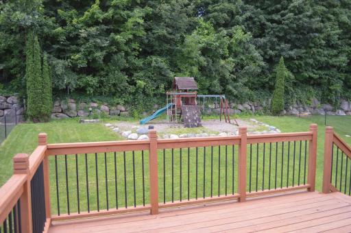 Large backyard with wooded back views. Playset stays!