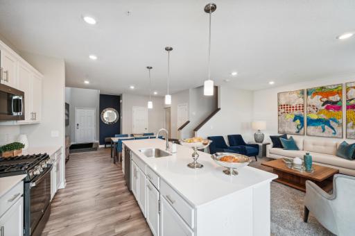 This home has a spacious kitchen with large island, quartz countertops, tile backsplash, white cabinets, pull out trash/recycling cabinet and Kitchen appliances! (*Photos of model home; colors and finishes will vary.)