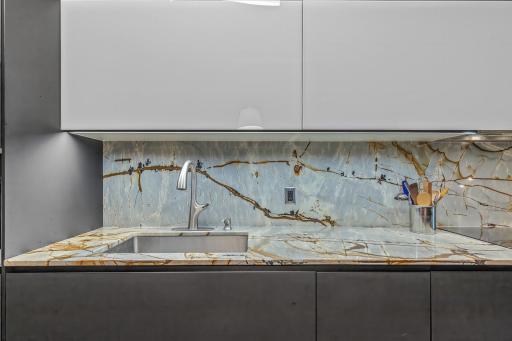 The countertop and backsplash are a gorgeous Blue Roma Quartzite stone from Brazil