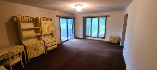 Primary bedroom with large, west facing window and sliding door to access the deck