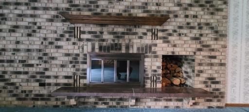 Let's take a closer look at the fireplace, with such a convenient space for storing logs.