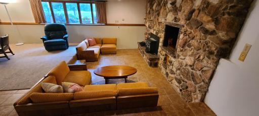 Sunken sitting area has in-floor heat. That, with the wood burning stove, is sure to keep you nice and cozy on the coldest of winter days