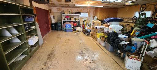 Inside of the garage. Epoxy floors and shelving for extra storage