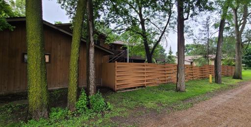 View of the side of the garage and backyard fence along the alley