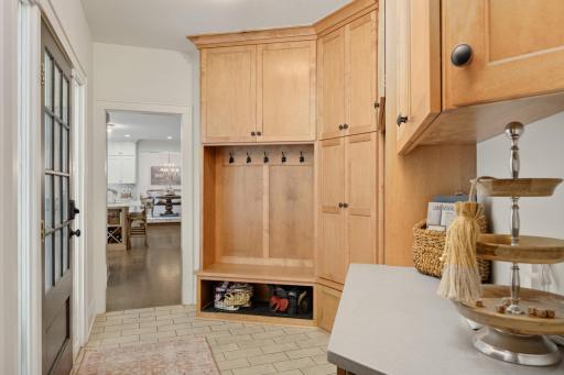 What a fantastic mud room! A wall of custom built cabinets and lockers, drop zone and although not pictured, a huge walk in closet is adjacent.