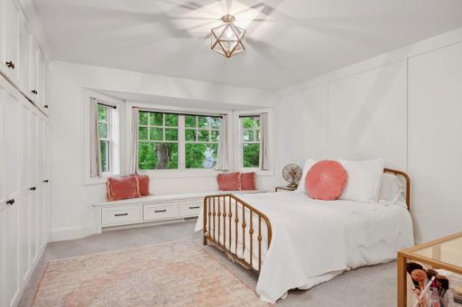 One of the three other upper level bedrooms, this space also features a wall of built in cabinetry for all you clothes, accessories or whatever you need. Plus another cute window seat with storage below.