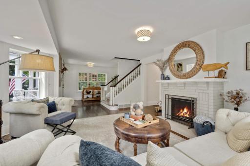 A wood burning fireplace with mantle brings a cozy feel to this space.