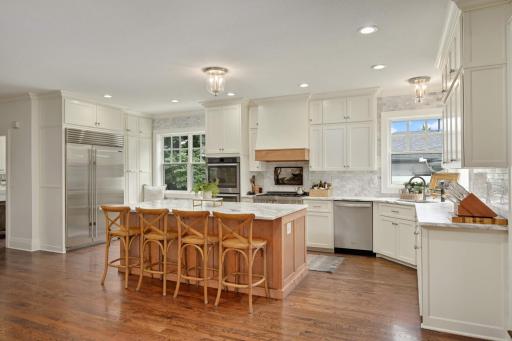 This gourmet kitchen was fully remodeled in 2018-2019. Full replacement with ceiling height custom cabinets with crown moulding, gorgeous marble countertops, natural stone backsplash, custom hood range and so much more!