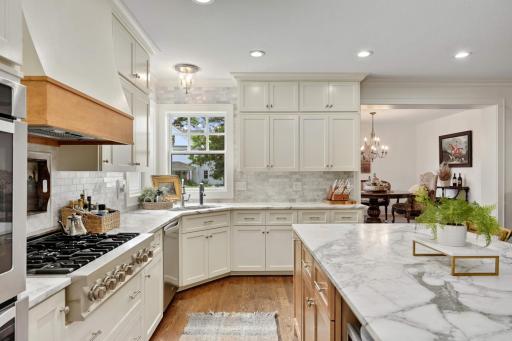 Channel your inner gourmet and embrace cooking on this beautiful gas range with custom hood vent.