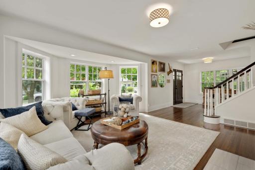 You will be "WOWED" from the moment you walk through the front door! Gorgeous hardwood floors, walls of windows, beautiful white enameled woodwork, crisp, clean decor and updated lighting encompass the formal living space!