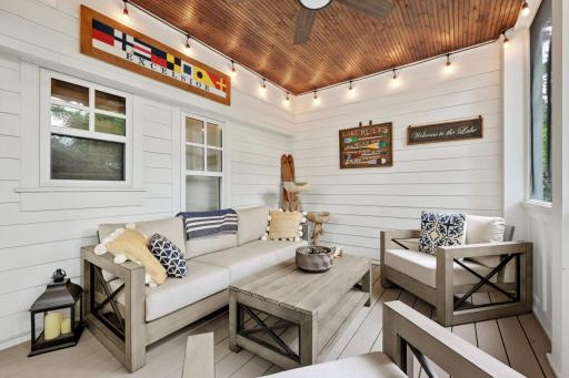 Make yourself comfortable in this darling screened porch. Azek composite decking continues from the exterior deck and is finished with ship lap walls and warmly stained wood ceiling with ceiling fan.
