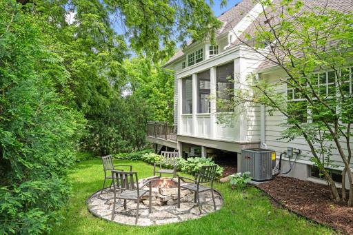 A fire pit area is located just off the deck and delineated with flagstone surround.