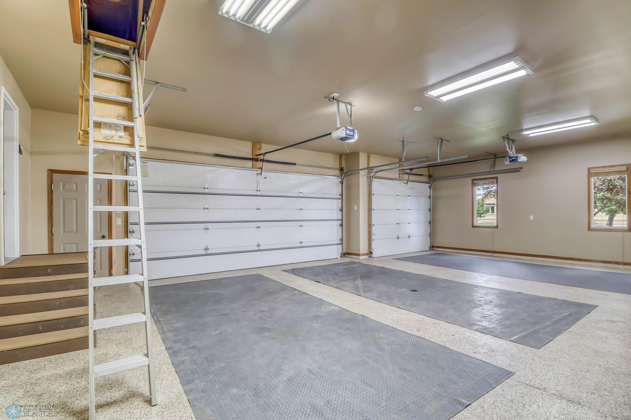 Garage - with epoxy floor and attic storage. Insulated and fully finished, with a floor drain. Also has service door to the back yard.