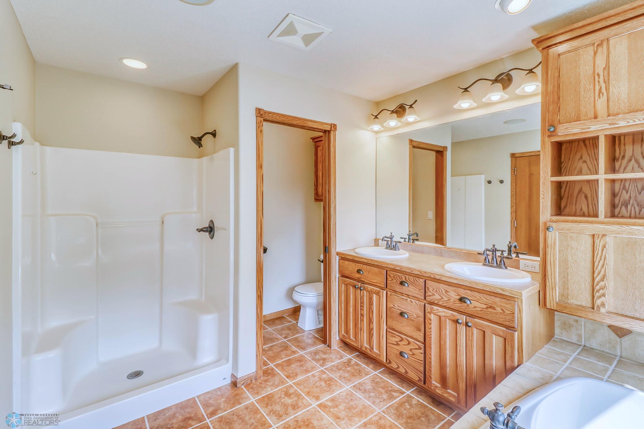 Primary Bathroom - dual sinks, water closet (toilet room) and separate soaking tub and shower