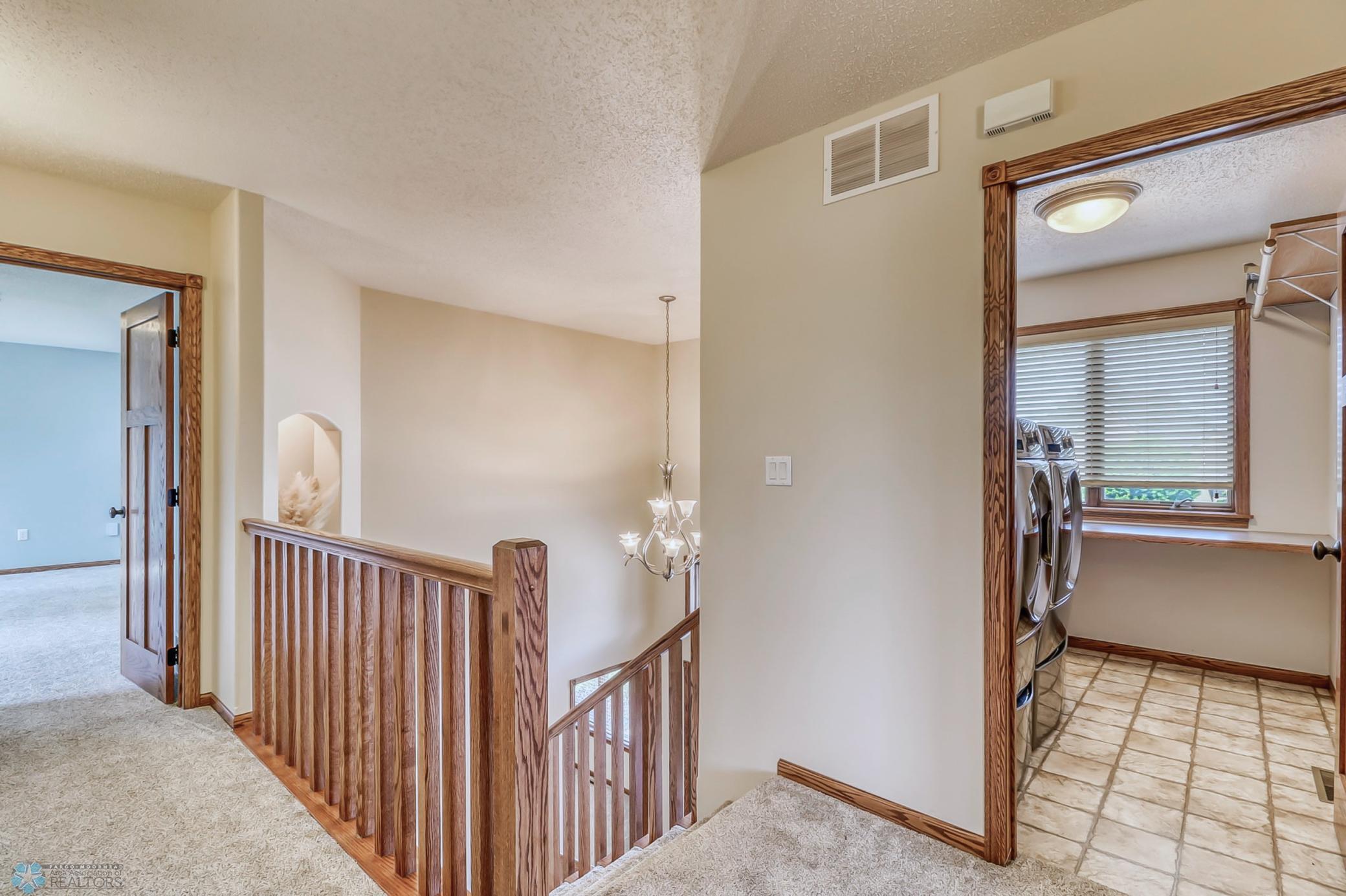 Upstairs - Large laundry room with space for folding and hanging. Even has a window!