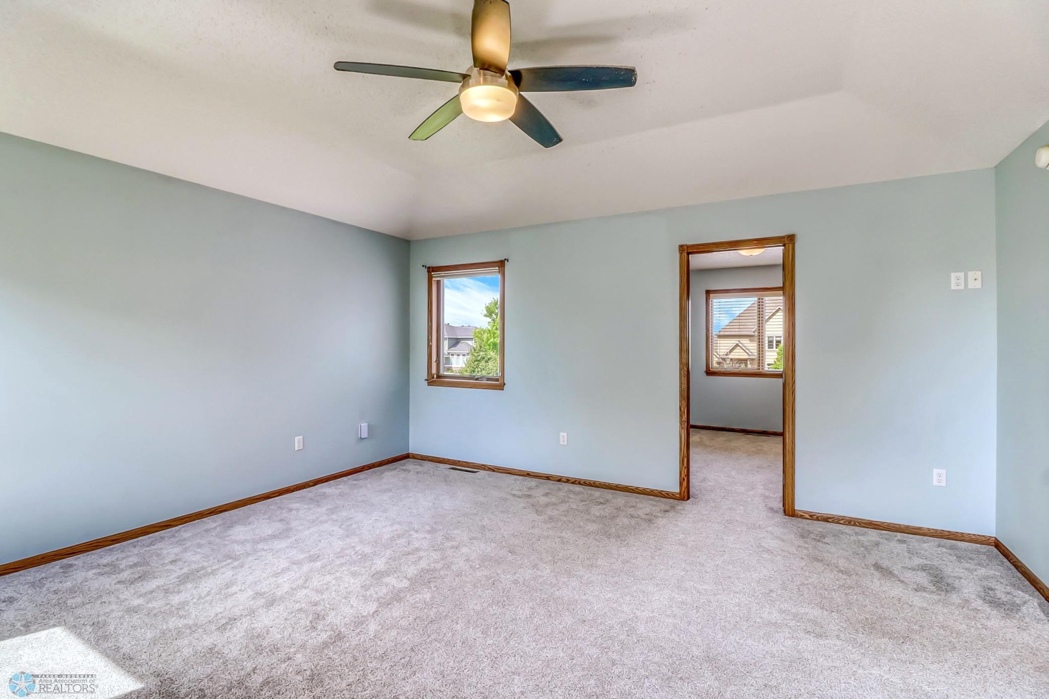 Primary Bedroom - has raised ceiling, ceiling fan, private full bath (with soaking tub and separate shower) and an ENORMOUS closet!