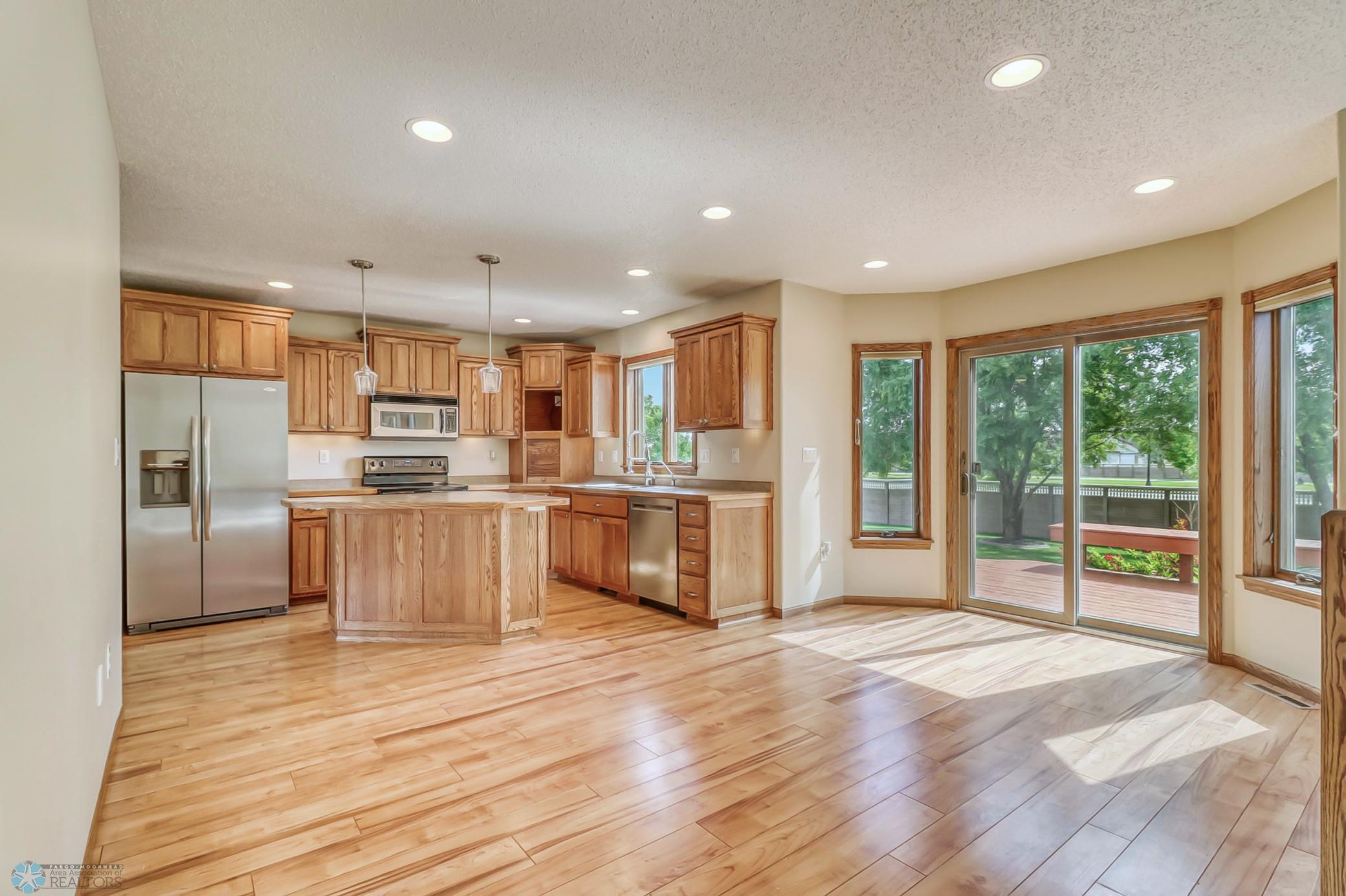 Dining and Kitchen: patio door, window above the sink, center island, pantry (not pictured)