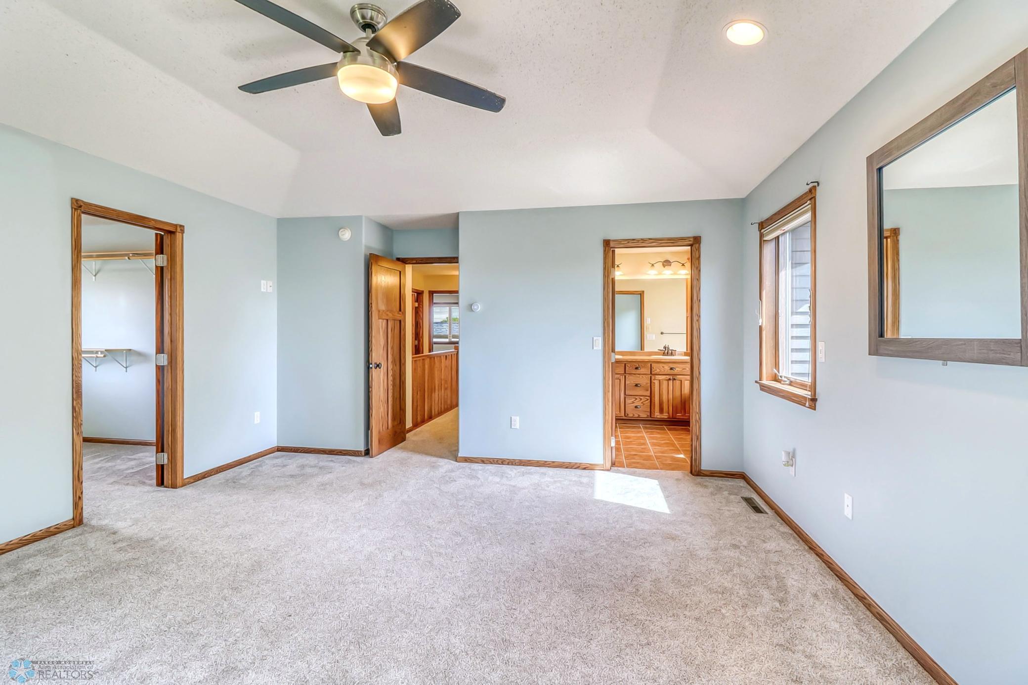 Primary Bedroom - has raised ceiling, ceiling fan, private full bath (with soaking tub and separate shower) and an ENORMOUS closet!
