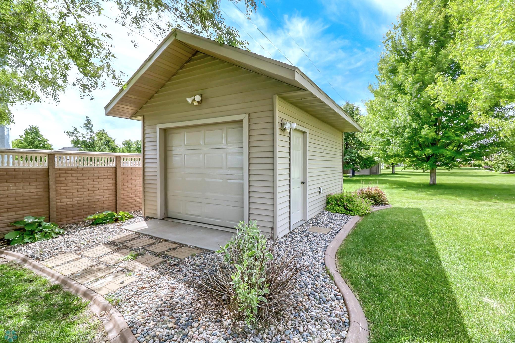 Shed Exterior - great storage! Concrete curb edging too.