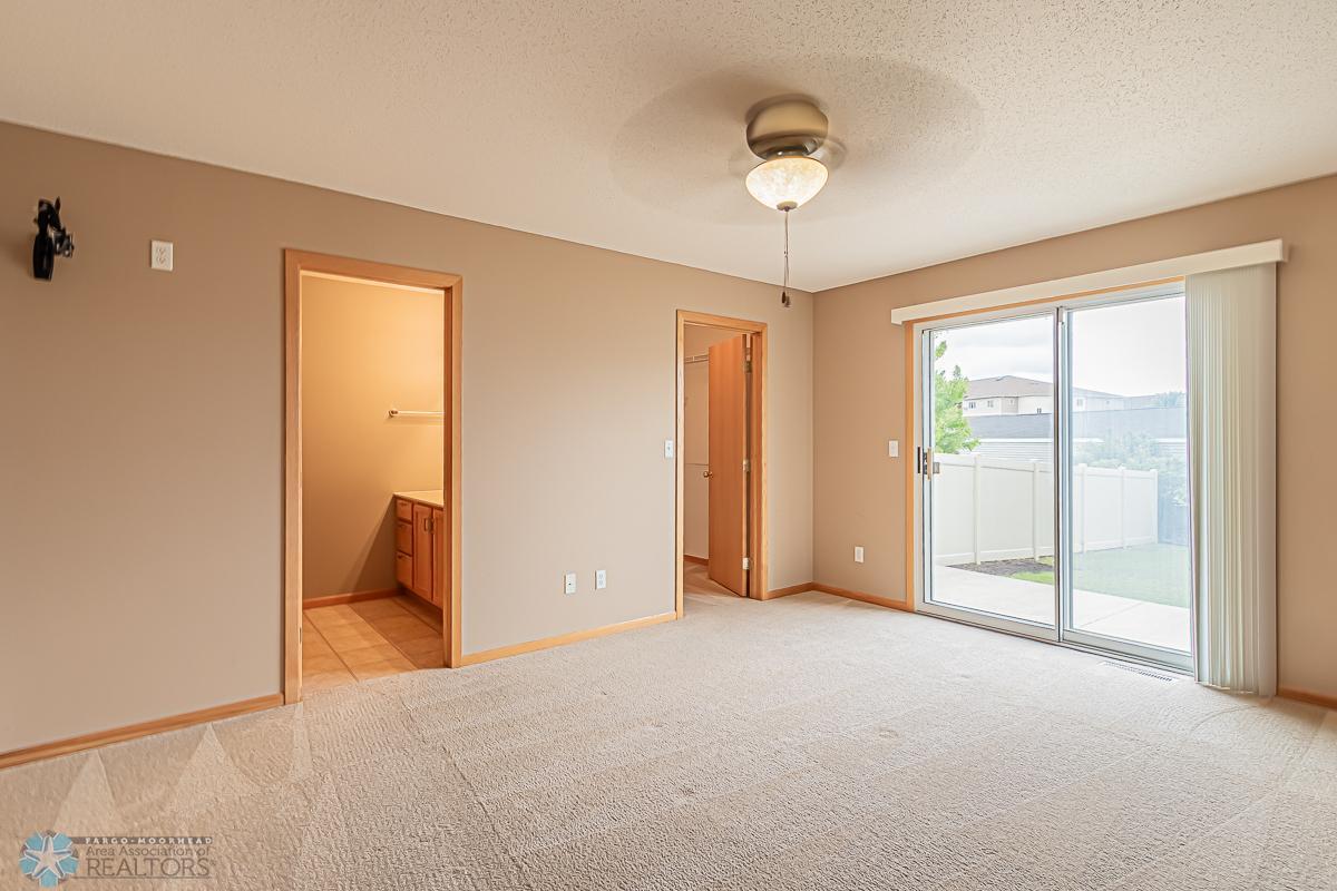Primary bedroom with private 3/4 bath, WIC & Patio access