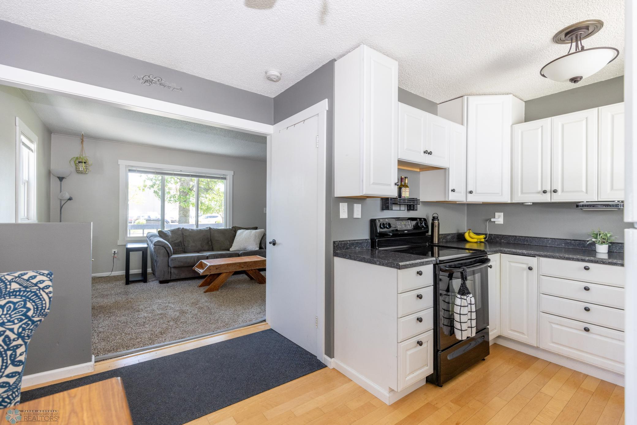 View into kitchen and door to basement on the right