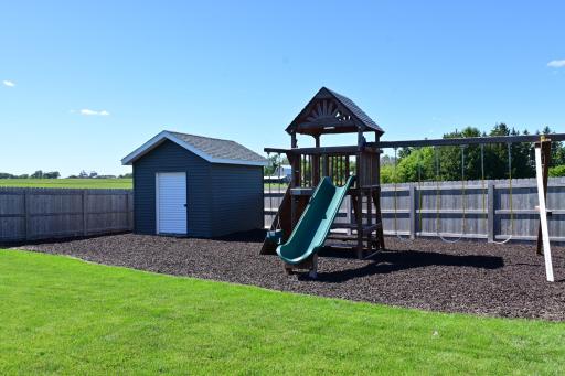 Rainbow swing set, rubber mulch, storage shed.JPG
