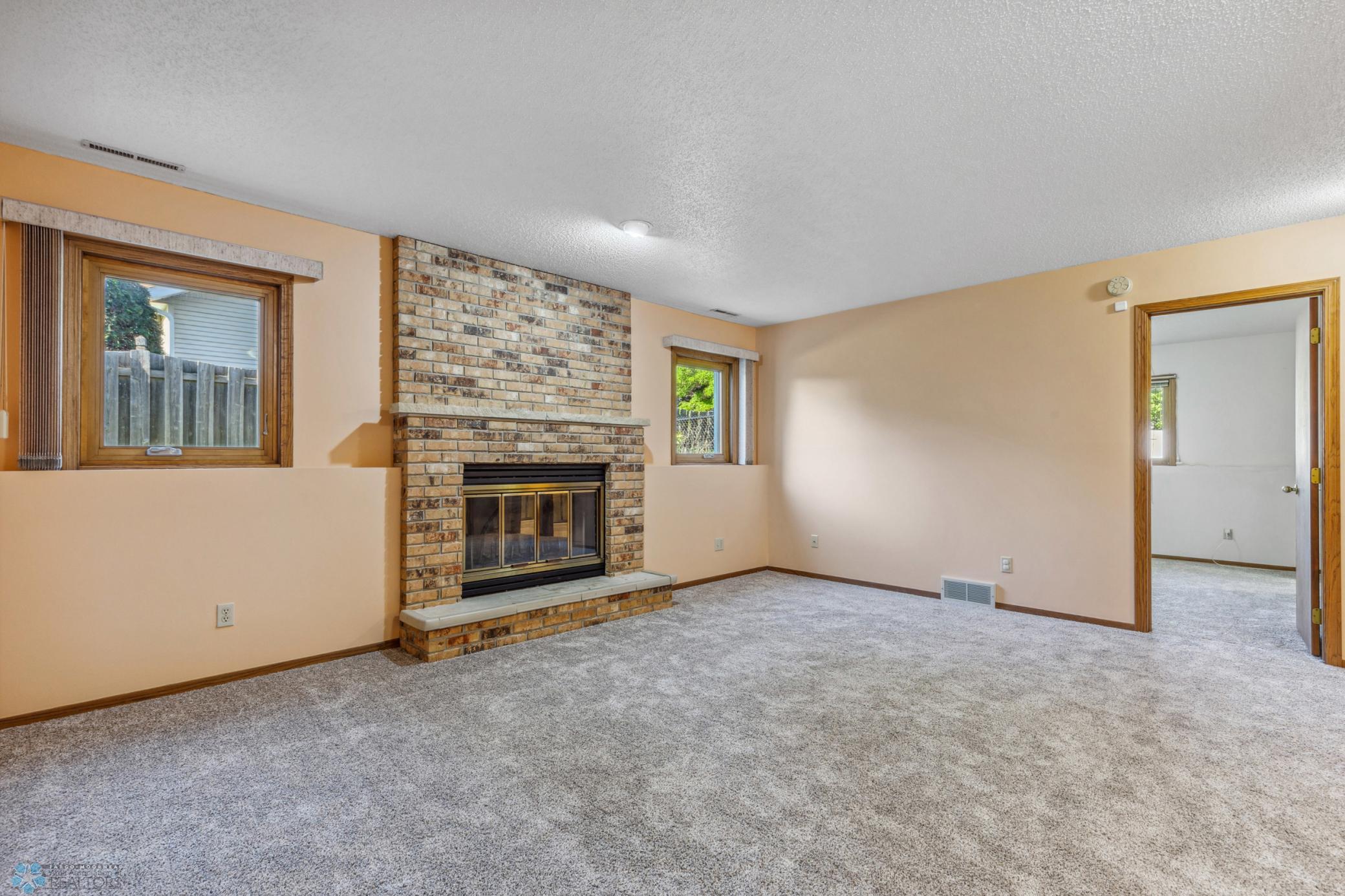 Lower Level Family Room with Brick Wood-Burning Fireplace