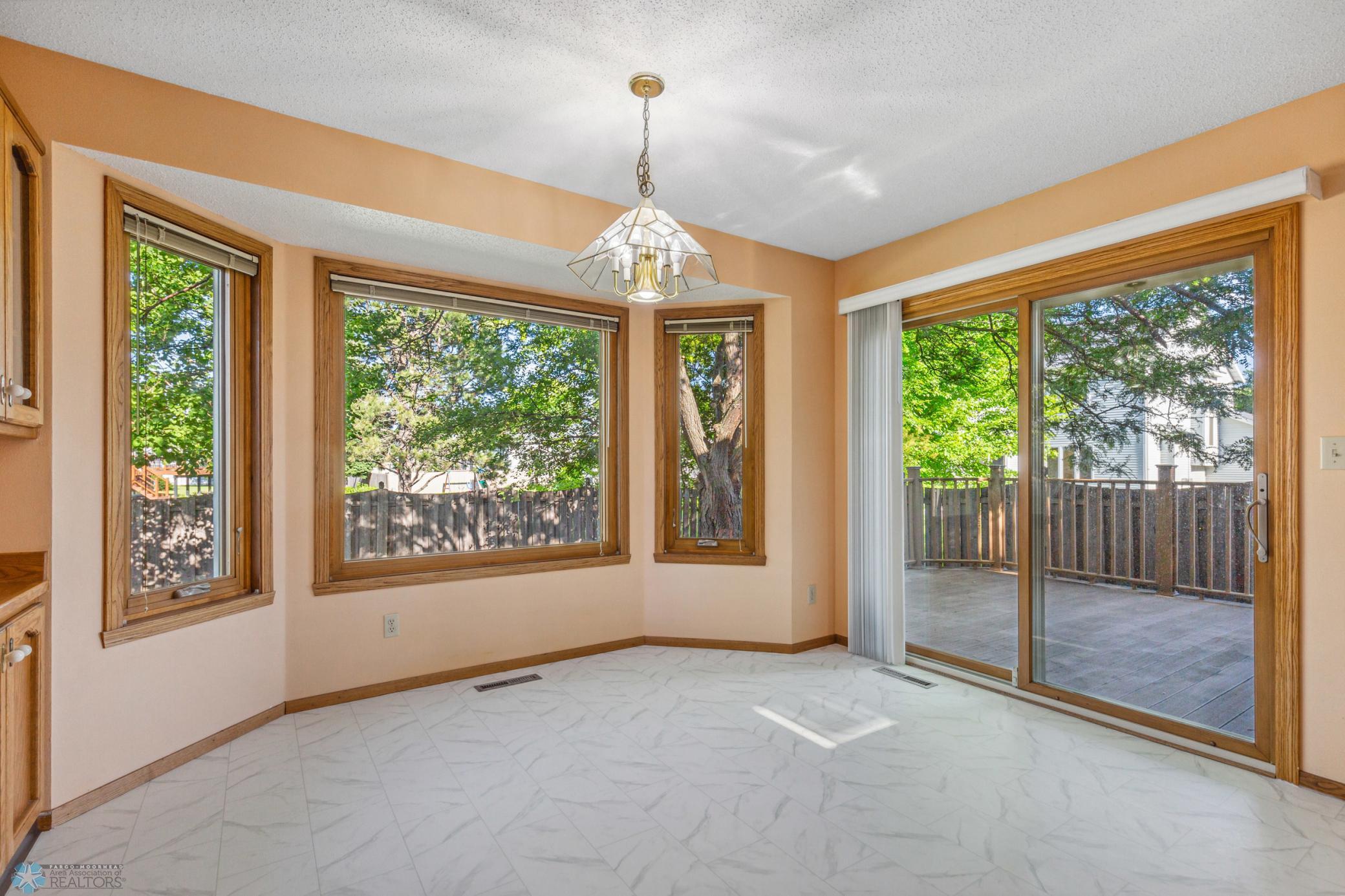 Eat-In Kitchen Area with new flooring and access to maintenance-free deck and fully fenced backyard