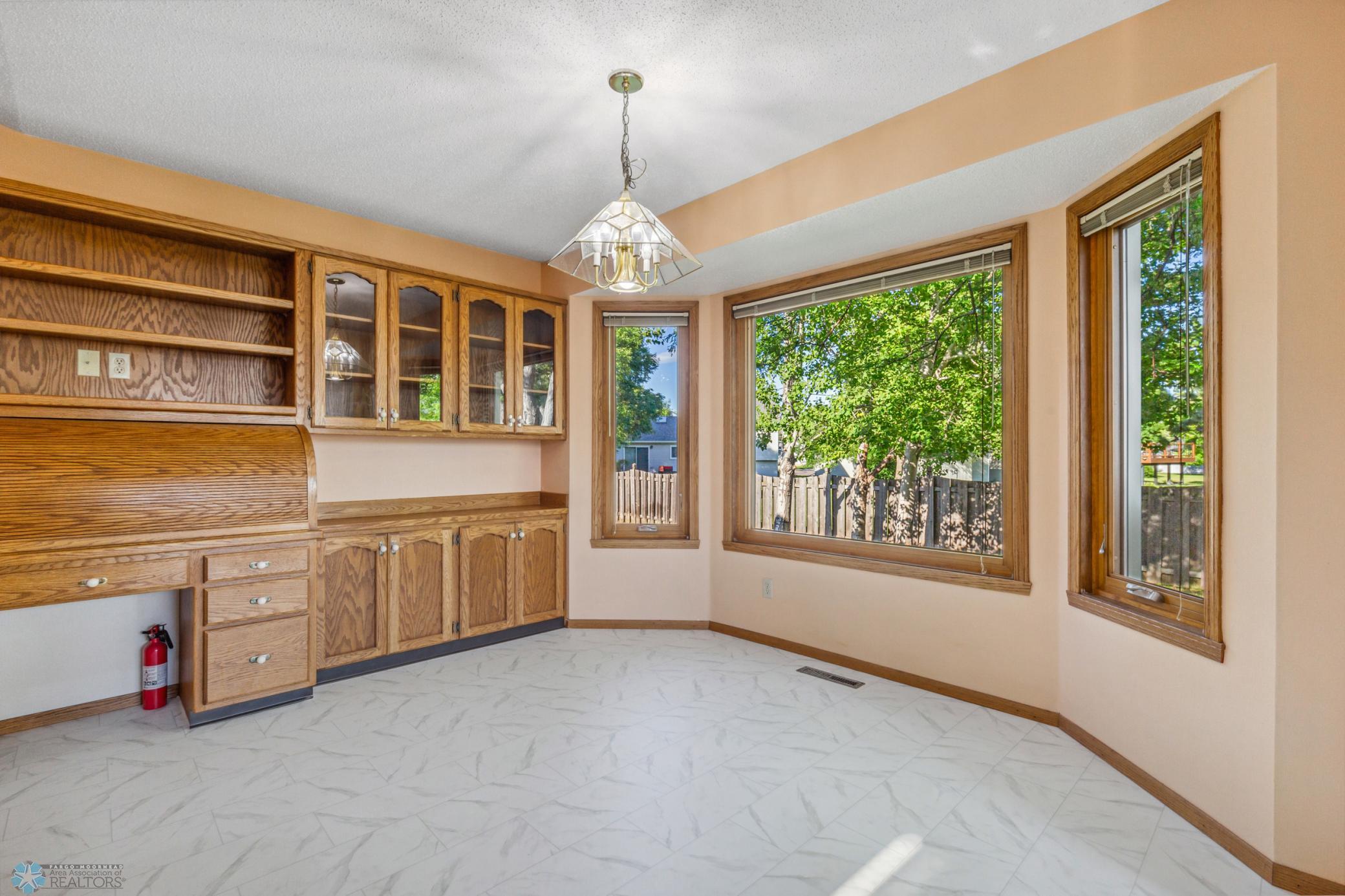 Eat-In Kitchen Area with new flooring and access to maintenance-free deck and fully fenced backyard