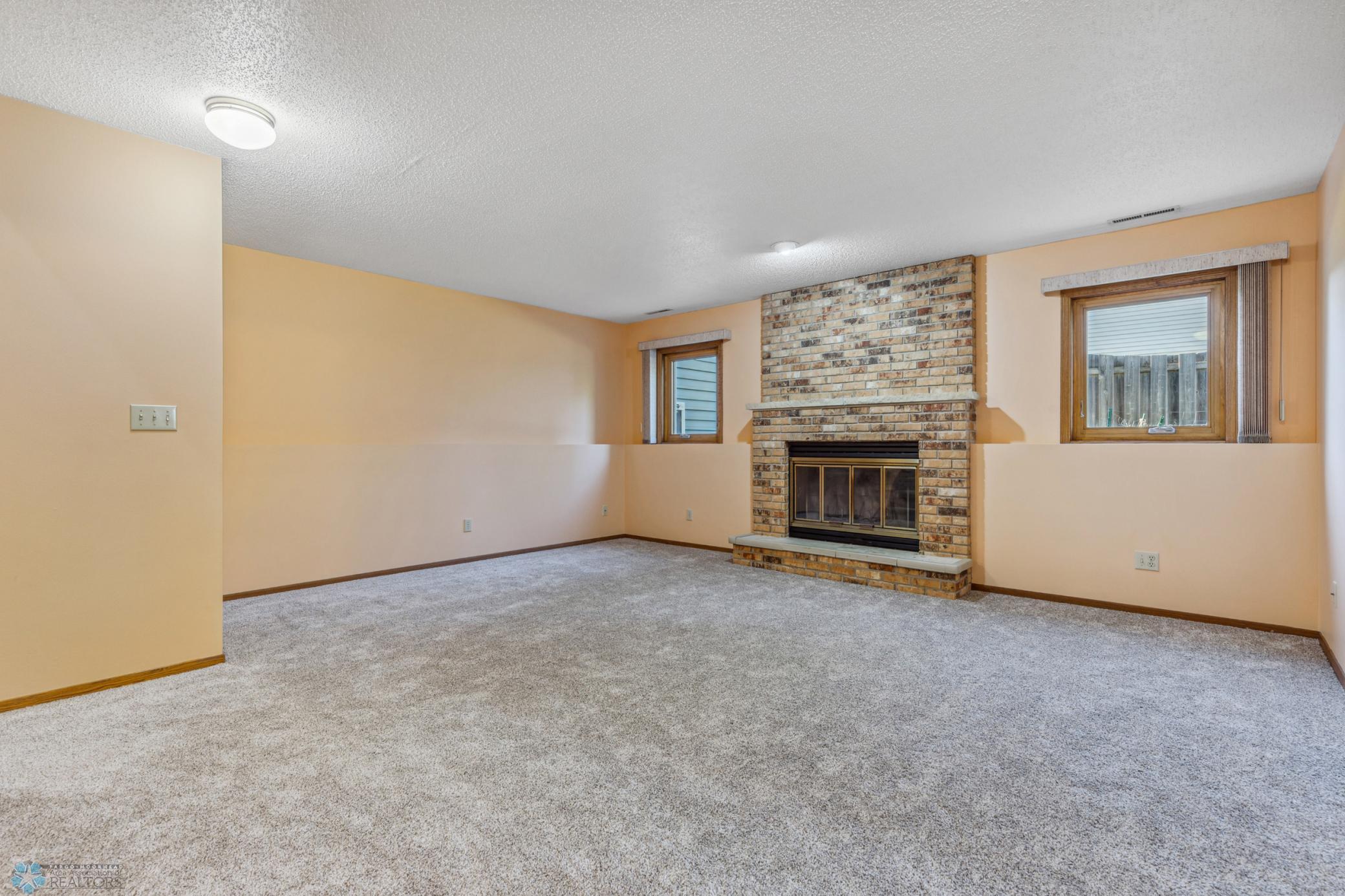 Lower Level Family Room with Brick Wood-Burning Fireplace