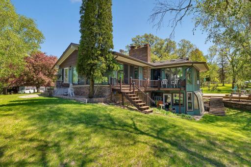 Main 4 bedroom home surrounded by beautiful grounds and a few steps to the heated pool hiding behind the house.