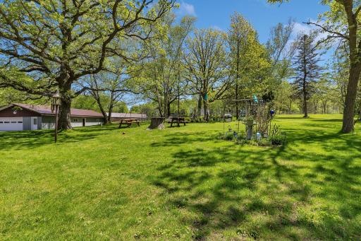 Back yard with workshop/small barn on left and loafing barn off farther.