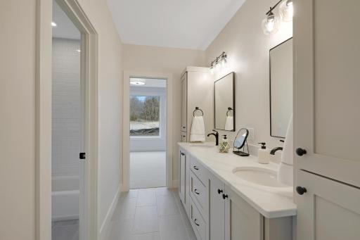 The lower level Jack-and-Jill bath features a double vanity.