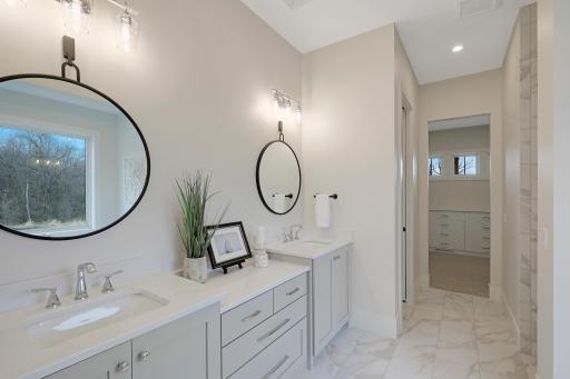 The master bath features a double vanity, separate tub and shower, and a heated floor.
