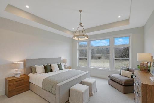 The spacious master suite offers space to relax and a perfect view of the property.