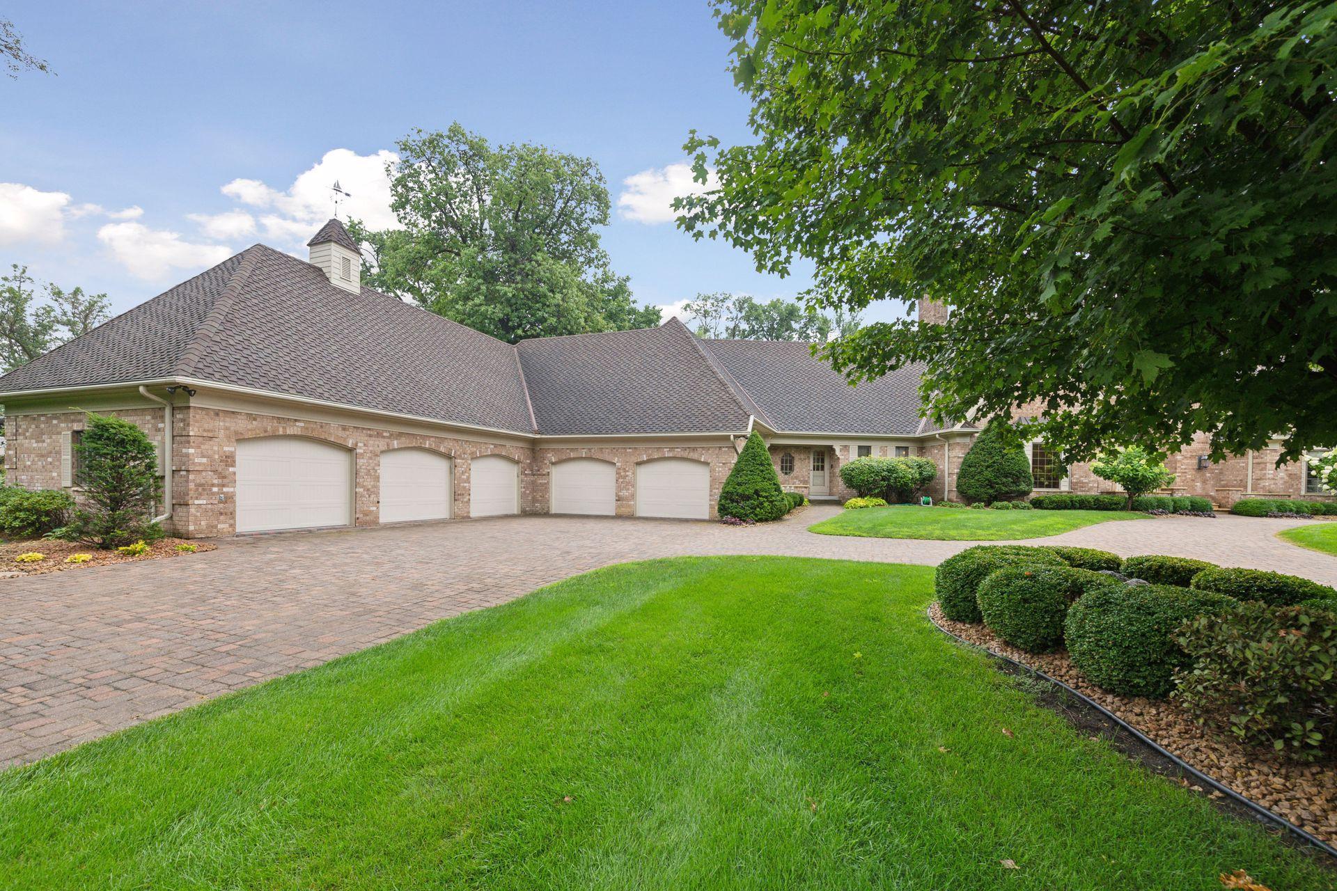 Five car garage includes heated space, a workshop room, and a storage room.