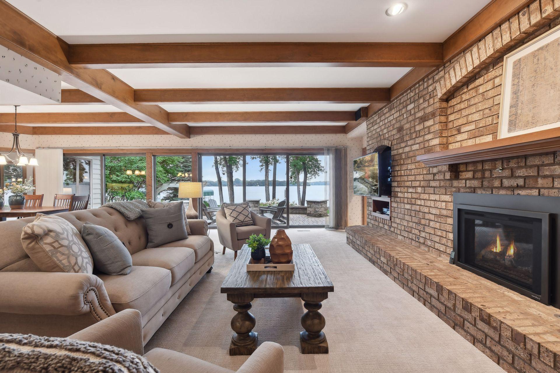 Family room with exposed brick wall and fireplace.