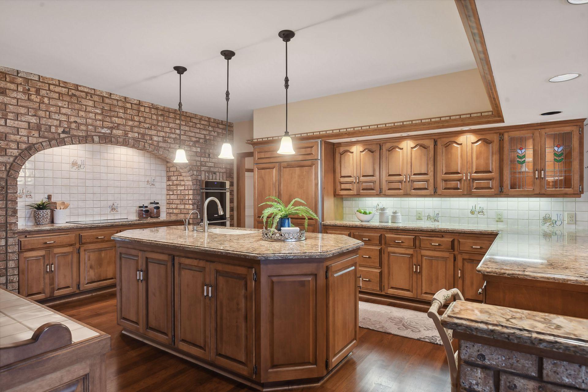 Spacious kitchen with exposed brick, wood floors, and plenty of workspace!