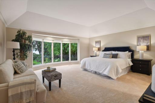 Spacious primary suite enjoys lake views.