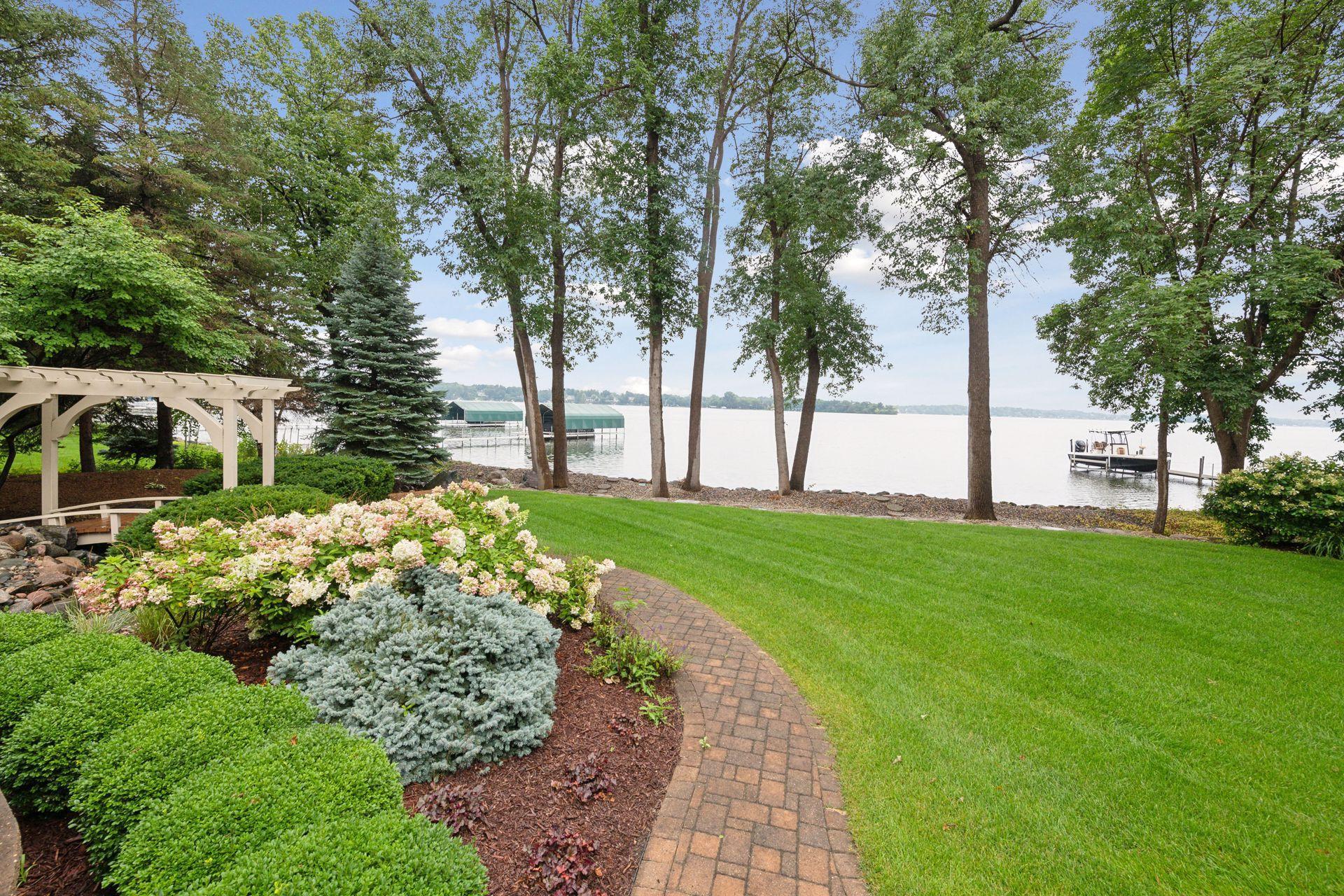 Enjoy the beautifully manicured grounds with 100 feet of lakeshore.