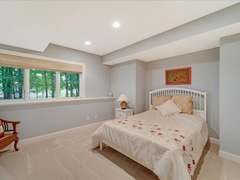 Lower level bedroom, large windows and lake views